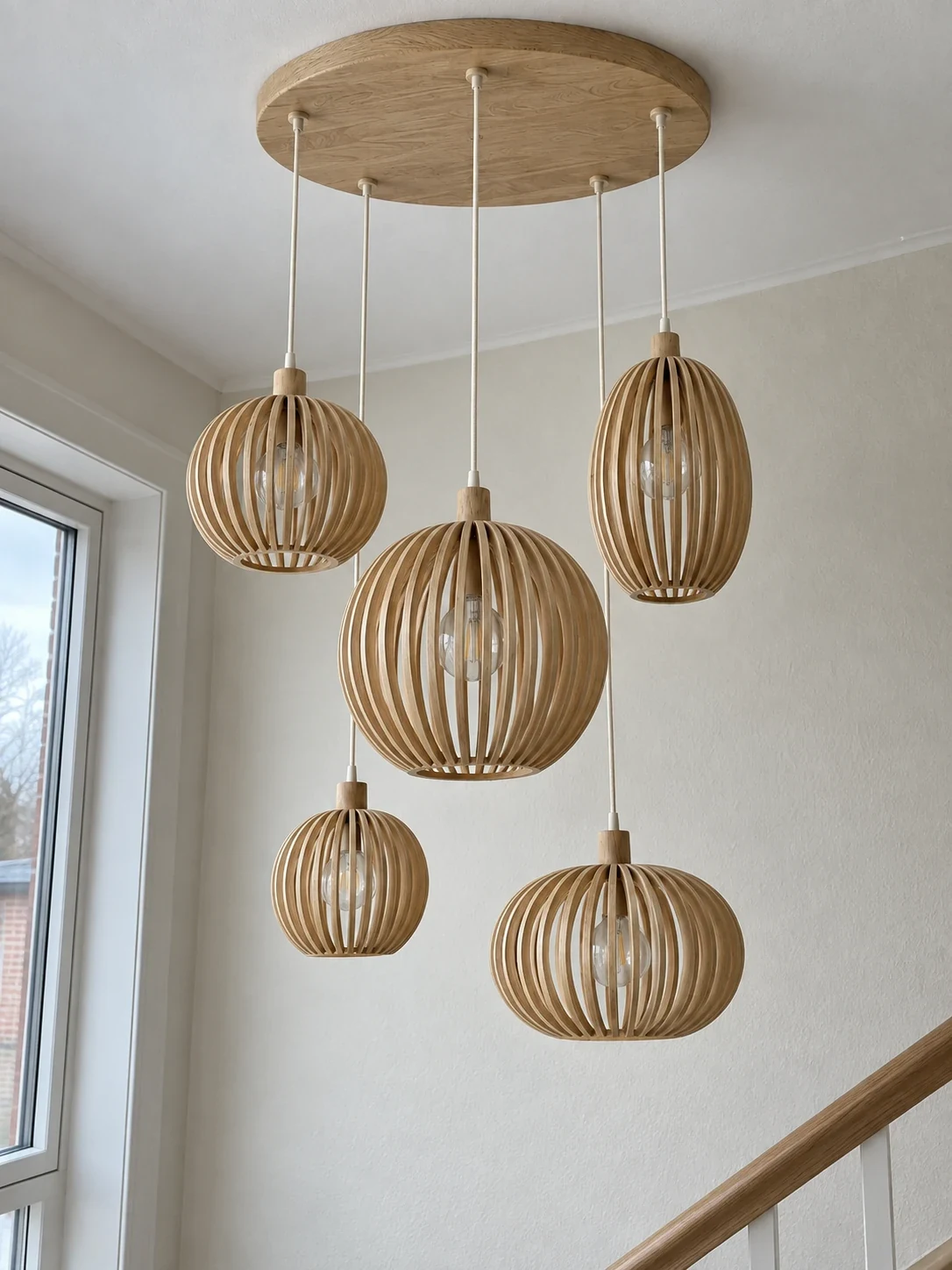 Five oak pendants in the Cascade 110 chandelier